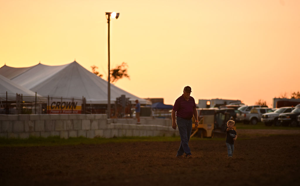Bobby Rankin and his grandson Julien Garrett, 2, play on the rodeo grounds
